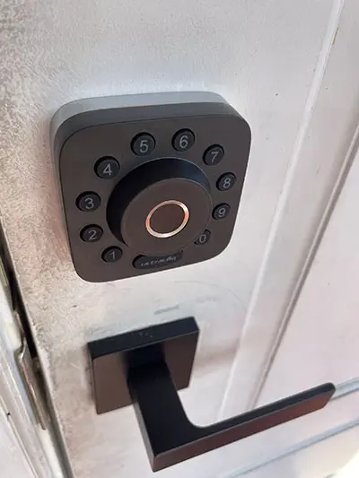 A black door knob with a button on it.